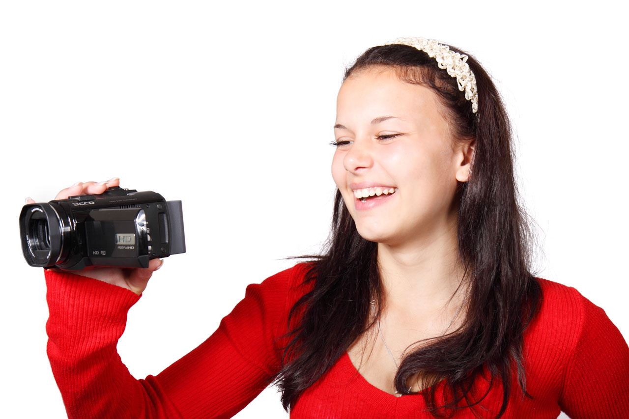 Teen using video camera public domain image