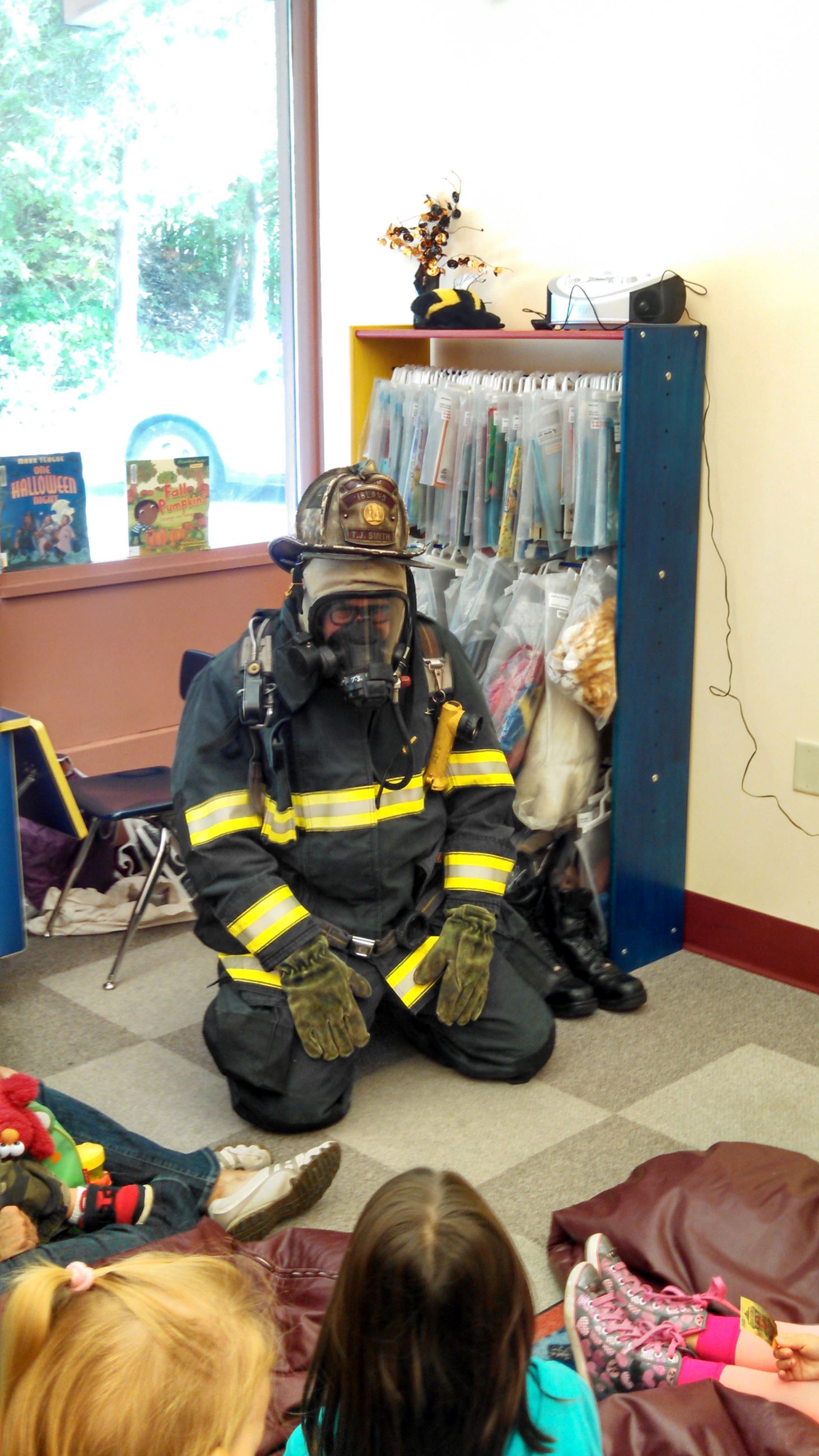 Firefighter in turn-out gear at a previous Firefighter Storytime