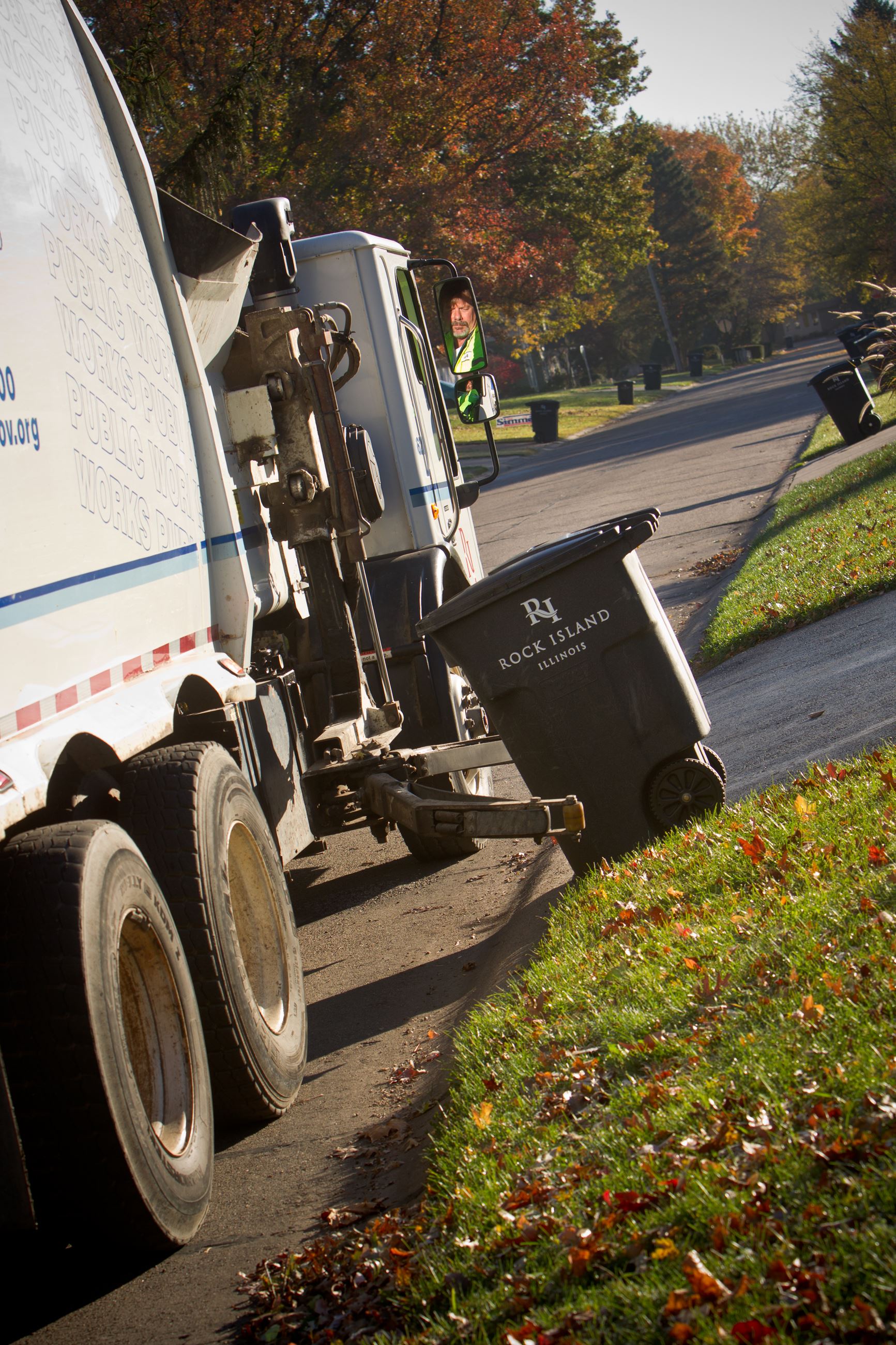 Refuse truck and cart in neighborhood 