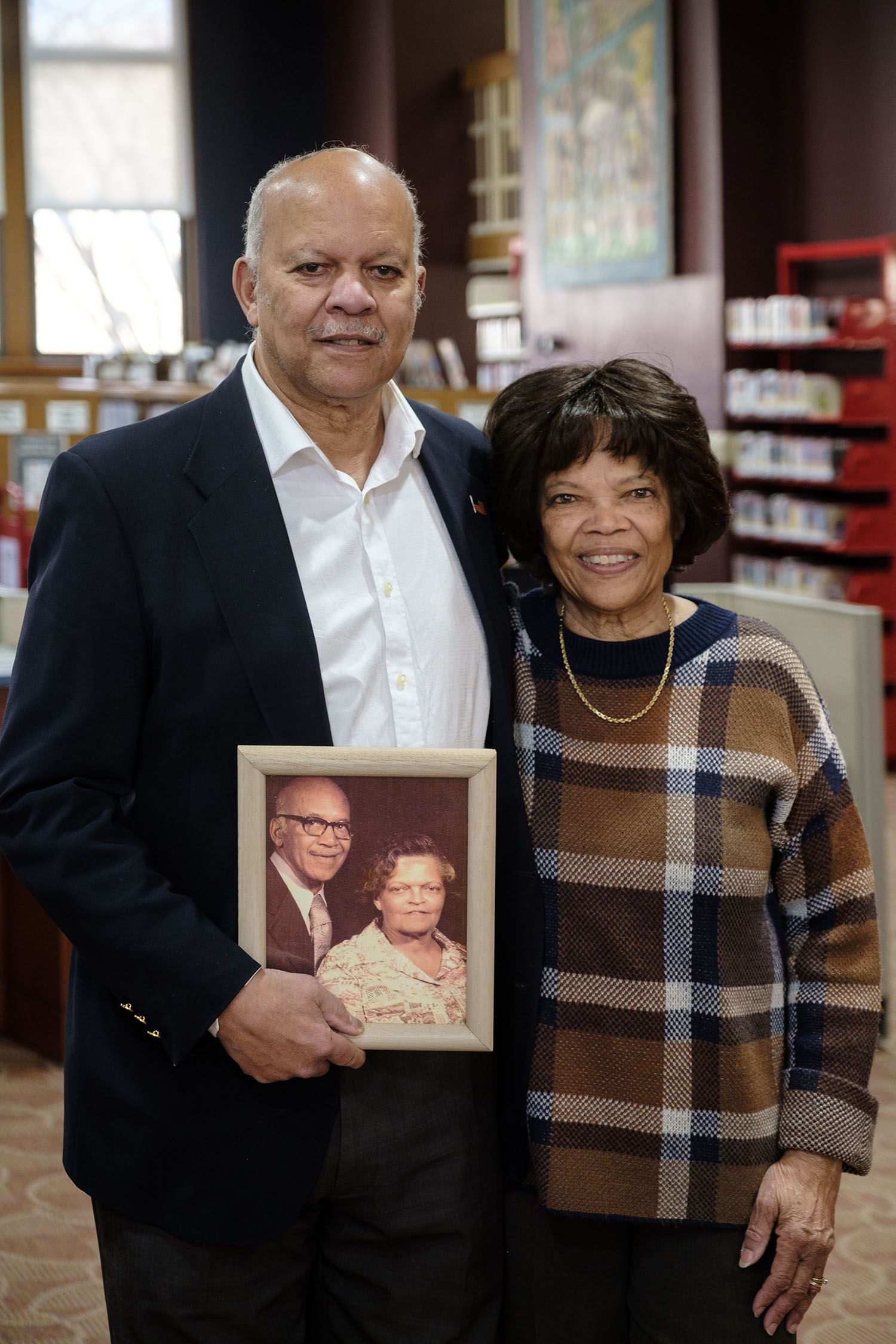Eudell Watts, III, and sister Marie Grigsby with photo of their late parents. 