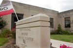 Centennial Bridge Visitor Center sign with open flag