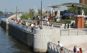 Visitors standing at edge near water of Schwiebert Riverfront Park